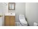 Neat half bathroom offers a sink, toilet, and neutral decor at 5406 Woodbreeze Dr, North Charleston, SC 29420