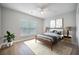 Sunlit bedroom with a large window, hardwood floors, a ceiling fan, and neutral paint at 5406 Woodbreeze Dr, North Charleston, SC 29420