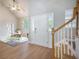 Bright and spacious foyer with hardwood floors, staircase, and view to study at 5406 Woodbreeze Dr, North Charleston, SC 29420
