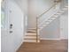 Inviting foyer featuring hardwood floors, stairs with white railing and a white front door at 5406 Woodbreeze Dr, North Charleston, SC 29420