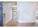 Bright foyer showcasing hardwood floors, stairs leading to the upper level and a view of the living room at 5406 Woodbreeze Dr, North Charleston, SC 29420