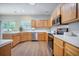 Bright kitchen featuring stainless steel appliances, light wood cabinetry, and white countertops at 5406 Woodbreeze Dr, North Charleston, SC 29420