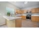 Well-lit kitchen with stainless steel appliances and light wood cabinets, offering a modern and functional space at 5406 Woodbreeze Dr, North Charleston, SC 29420