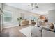 Inviting living room with a fireplace and an open floor plan that leads into a modern eat-in kitchen at 5406 Woodbreeze Dr, North Charleston, SC 29420