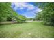 Scenic view of a pond surrounded by lush greenery and mature trees in the backyard at 5406 Woodbreeze Dr, North Charleston, SC 29420