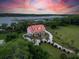 Stunning aerial view of a waterfront estate with lush greenery and a private driveway at 5625 Crystal Harbor Ln, Hollywood, SC 29449