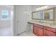 Elegant bathroom featuring a vanity area, custom cabinetry and countertop, and modern fixtures at 5625 Crystal Harbor Ln, Hollywood, SC 29449