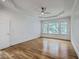 Bright primary bedroom with hardwood flooring, a ceiling fan, and windows offering natural light at 5625 Crystal Harbor Ln, Hollywood, SC 29449