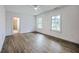 Bright and airy bedroom featuring hard surface floors, ensuite access, and multiple windows for natural light at 5625 Crystal Harbor Ln, Hollywood, SC 29449