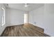 Minimalist bedroom with hardwood floors, white walls, a window, and a white door at 5625 Crystal Harbor Ln, Hollywood, SC 29449