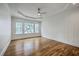 Spacious bedroom features hardwood floors, a modern ceiling fan, and natural light from multiple windows at 5625 Crystal Harbor Ln, Hollywood, SC 29449