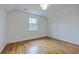Bright bedroom with hardwood floors, white walls, a window, and a modern ceiling light at 5625 Crystal Harbor Ln, Hollywood, SC 29449