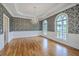 Spacious dining room with hardwood floors, a chandelier, and large windows for ample natural light at 5625 Crystal Harbor Ln, Hollywood, SC 29449