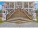Grand staircase leading to the front entrance, flanked by lion statues at 5625 Crystal Harbor Ln, Hollywood, SC 29449