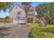 Traditional two-story home features a three-car garage, second floor balcony, and beautiful landscaping at 5625 Crystal Harbor Ln, Hollywood, SC 29449