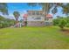 Beautifully landscaped backyard featuring a large home with a red roof and multiple outdoor living spaces at 5625 Crystal Harbor Ln, Hollywood, SC 29449