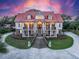 Elegant home with a red roof, grand staircase, and manicured landscaping for an inviting curb appeal at 5625 Crystal Harbor Ln, Hollywood, SC 29449