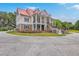 Beautiful two-story home with red roof, columns, landscaped yard, and circular driveway at 5625 Crystal Harbor Ln, Hollywood, SC 29449