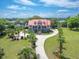 Aerial view of a beautiful house, large yard, circular driveway, and mature trees at 5625 Crystal Harbor Ln, Hollywood, SC 29449