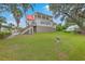 Expansive home with a red roof, multiple decks, and lush landscaping, offering ample outdoor living space at 5625 Crystal Harbor Ln, Hollywood, SC 29449