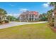 Stately two-story home with a red roof, white columns, and circular driveway at 5625 Crystal Harbor Ln, Hollywood, SC 29449