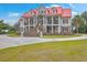 Charming two-story home with a striking red roof, columns, and manicured front lawn at 5625 Crystal Harbor Ln, Hollywood, SC 29449