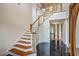 Elegant foyer with staircase, chandelier, and marble floors at 5625 Crystal Harbor Ln, Hollywood, SC 29449