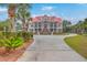 View showcases the grand house, circular driveway, and lush tropical landscaping at 5625 Crystal Harbor Ln, Hollywood, SC 29449