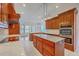Spacious kitchen boasts custom wood cabinetry, stainless appliances, marble counters and kitchen island at 5625 Crystal Harbor Ln, Hollywood, SC 29449