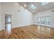 Bright living room with hardwood floors, vaulted ceiling, skylights, and French doors to a deck at 5625 Crystal Harbor Ln, Hollywood, SC 29449