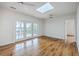 Open-concept living room with hardwood floors, French doors to a deck, and views of the lake at 5625 Crystal Harbor Ln, Hollywood, SC 29449