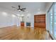 Bright living room features built-in shelves, fireplace, ceiling fan, and sliding glass doors at 5625 Crystal Harbor Ln, Hollywood, SC 29449