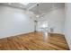 Bright living room with hardwood floors and vaulted ceiling with a glimpse into a second-story hallway at 5625 Crystal Harbor Ln, Hollywood, SC 29449