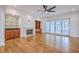 Open living room with fireplace, wet bar, built-in shelves, ceiling fan, and sliding glass doors at 5625 Crystal Harbor Ln, Hollywood, SC 29449