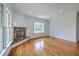 Light-filled living room featuring hardwood floors, a decorative fireplace, and a large bay window at 5625 Crystal Harbor Ln, Hollywood, SC 29449