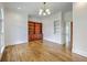 Inviting office space with wood floors, custom shelving, and ample natural light from large windows at 5625 Crystal Harbor Ln, Hollywood, SC 29449