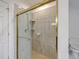 Bathroom shower featuring glass door and tile surround at 5625 Crystal Harbor Ln, Hollywood, SC 29449