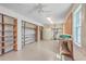 Large storage room is equipped with utility shelving, water storage, a work bench, and a bright, clean interior at 5625 Crystal Harbor Ln, Hollywood, SC 29449