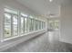 Bright sunroom featuring a wall of windows with scenic views, offering a serene living space at 5625 Crystal Harbor Ln, Hollywood, SC 29449