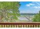 Picturesque waterfront view with a long wooden pier from a wooden deck, creating a serene outdoor space at 5625 Crystal Harbor Ln, Hollywood, SC 29449