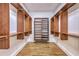 A neatly arranged walk-in closet with wooden shelving and a light wood floor is great for organization at 5625 Crystal Harbor Ln, Hollywood, SC 29449