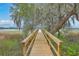 Picturesque walkway with mature trees and marsh views at 5625 Crystal Harbor Ln, Hollywood, SC 29449