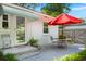 Cozy outdoor patio with a table and chairs, perfect for enjoying the beautiful backyard at 672 W Oak Forest Dr, Charleston, SC 29407