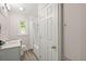 Bathroom with a tiled shower, white vanity, and linen closet at 672 W Oak Forest Dr, Charleston, SC 29407