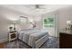Comfortable bedroom with neutral tones, a ceiling fan, and windows providing a view of the outdoors at 672 W Oak Forest Dr, Charleston, SC 29407