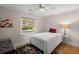 Cozy bedroom with ceiling fan, hardwood floors and large window at 672 W Oak Forest Dr, Charleston, SC 29407
