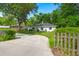 This charming home features a long driveway and mature trees providing shade, privacy, and curb appeal at 672 W Oak Forest Dr, Charleston, SC 29407