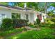 Front exterior view of a charming home with a quaint porch swing and an American flag at 672 W Oak Forest Dr, Charleston, SC 29407