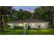 Charming single-story home with a well-manicured lawn, inviting curb appeal and an American flag at 672 W Oak Forest Dr, Charleston, SC 29407