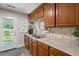 Kitchen featuring stainless steel appliances, wood cabinets, and view to backyard at 672 W Oak Forest Dr, Charleston, SC 29407